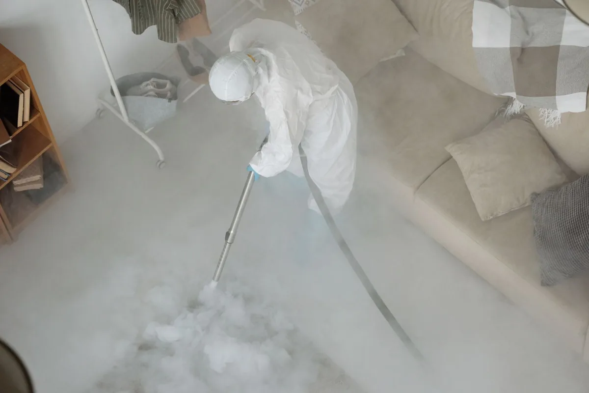 Biohazard cleanup technician in protective equipment, Merriam, KS